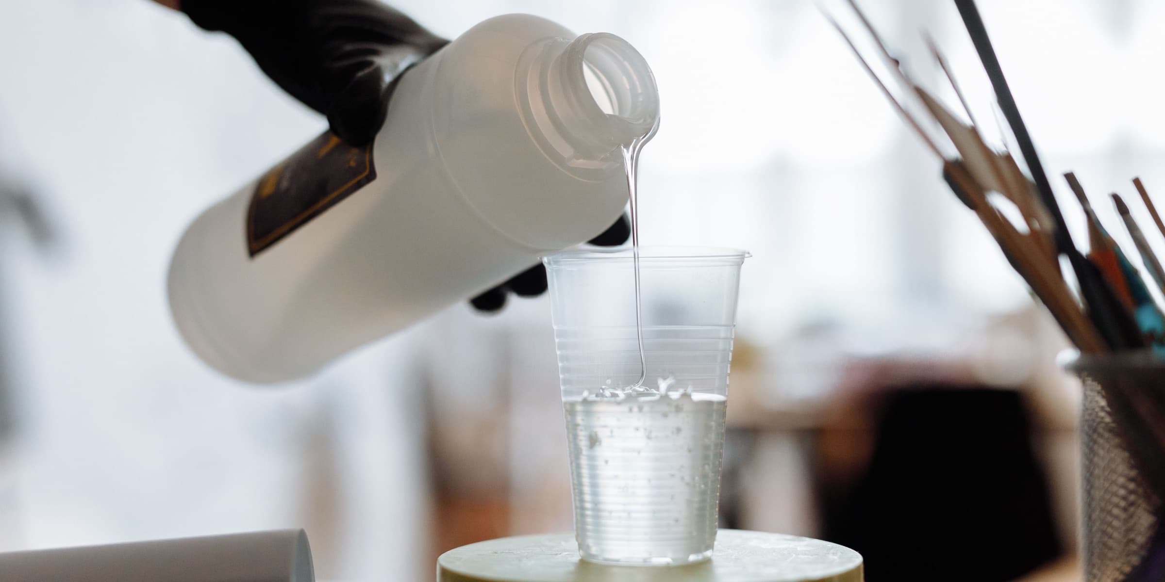 Resin being poured into a plastic cup