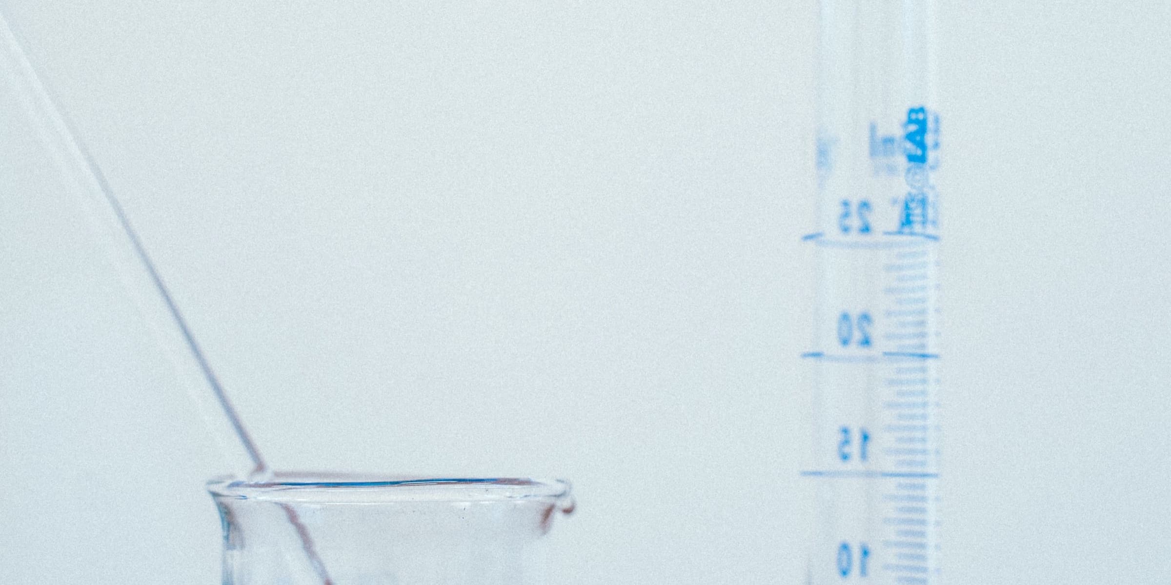 Beaker of blue liquid and a graduated cylinder